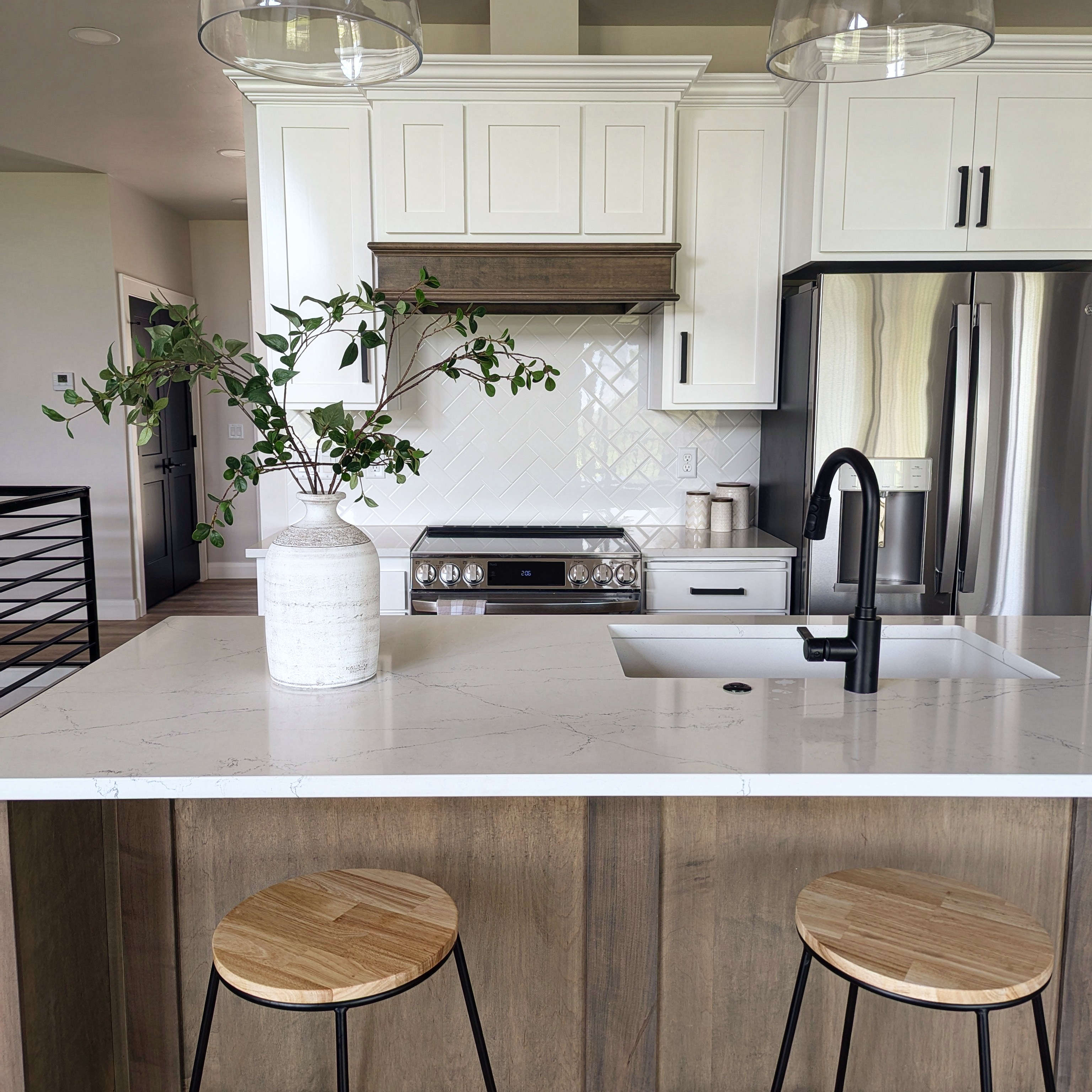 Finished kitchen with custom cabinetry, hood surround and trim work