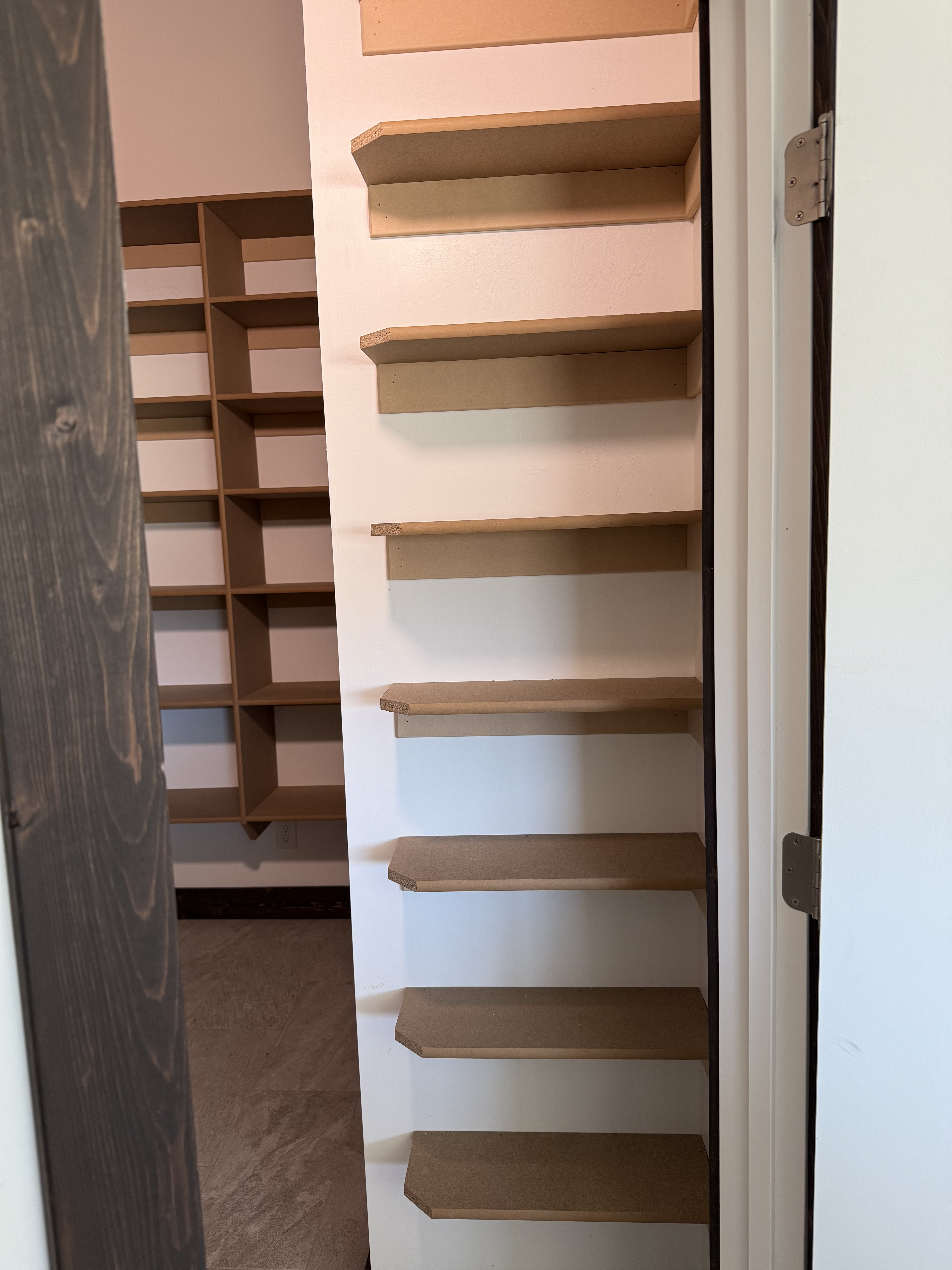 Built-in pantry shelves with barn door detail