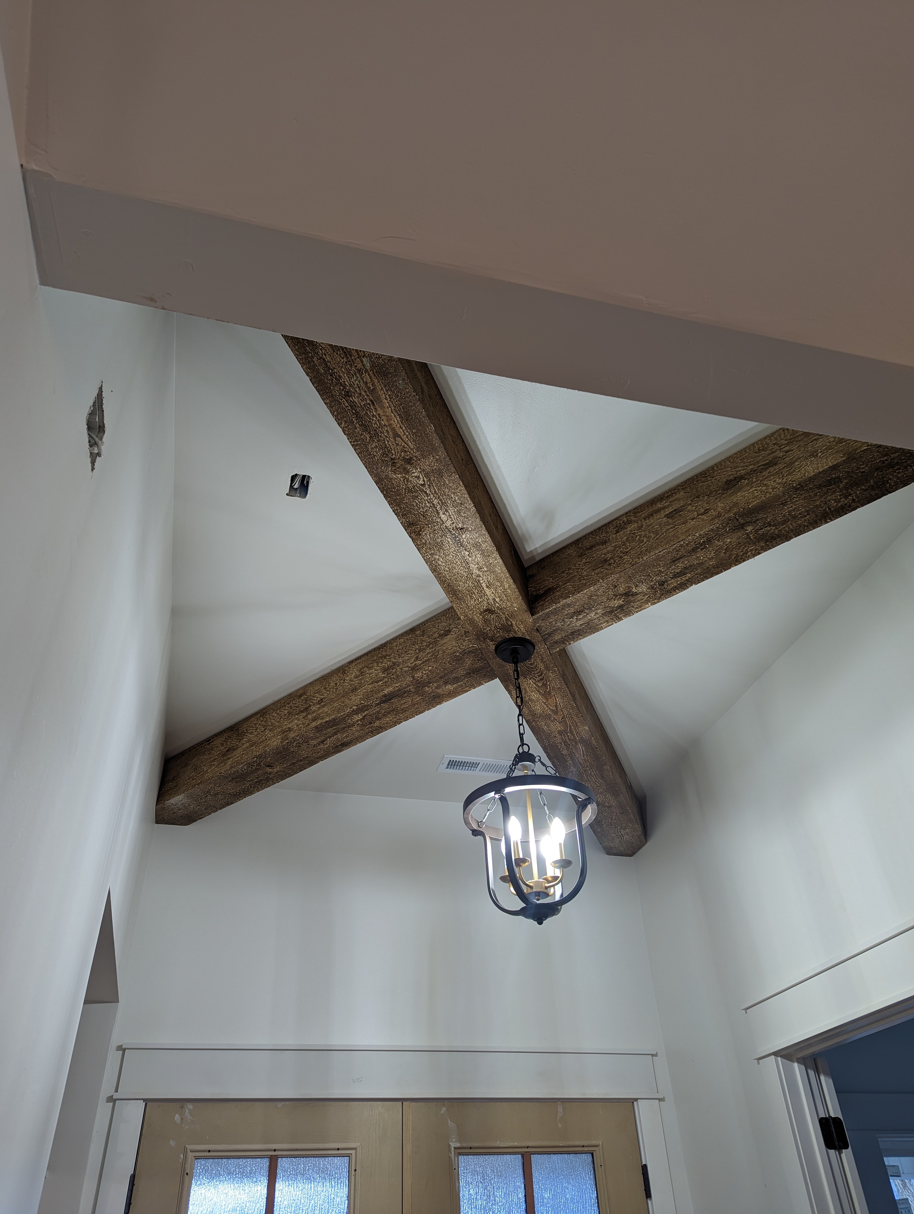 Exposed Wood Beam Ceiling with Vaulted Entry